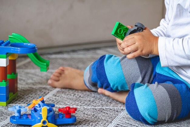 Kind spelen met blokken zittend op de vloer