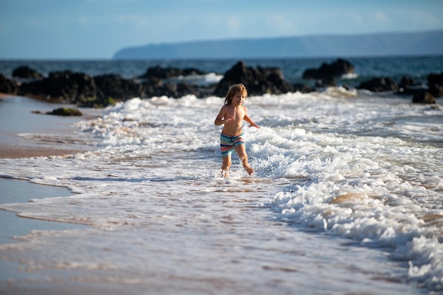 Kind springen in zee oceaan golven springen door water spatten zomerdag oceaan kust strand actieve kinderen levens