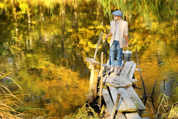 Kind vissen in een rivier zittend op een houten ponton