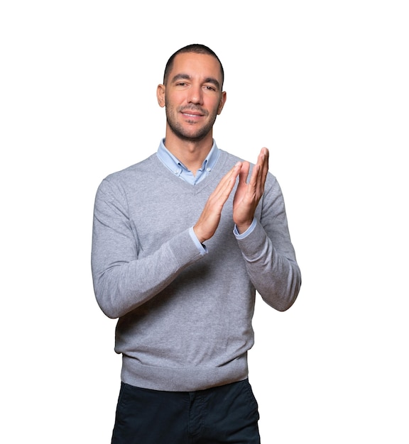 Kind young man doing an applauding gesture