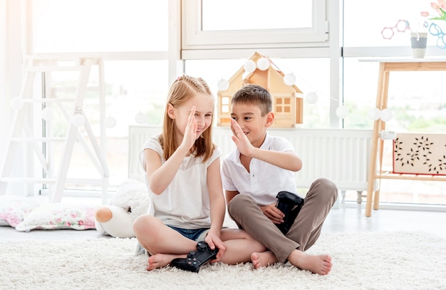 Kinderen geven high five tijdens het gamen