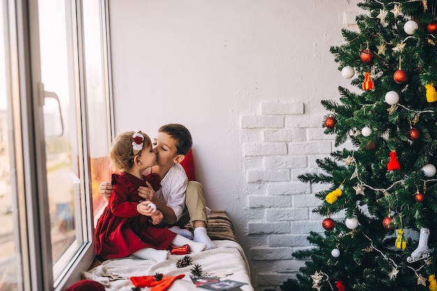 Kinderen in de buurt van de kerstboom. Nieuwjaar