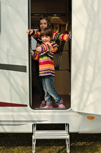 Kinderen in de camper hebben plezier, reizen met het gezin in de camper tijdens een vakantievakantie op de camping