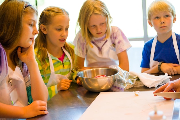 Foto kinderen leren koken in een kookles.