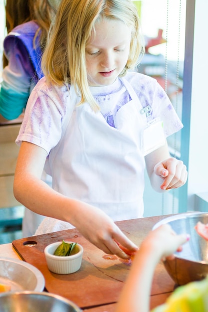 Kinderen leren koken in een kookles.