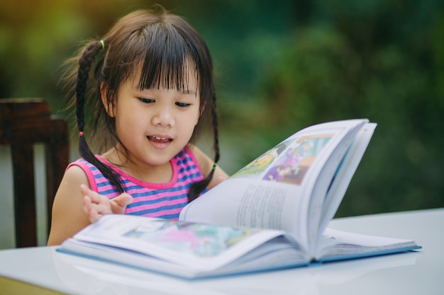 Kinderen lezen van een boek en huiswerk.