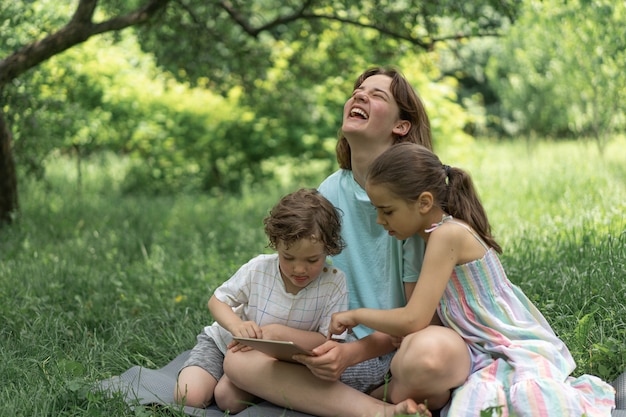 Kinderen met een tablet buitenshuis kinderen spelen spelletjes op het tablettechnologieconcept