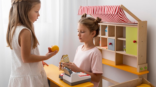 Foto kinderen spelen binnenshuis samen met een marketingspel