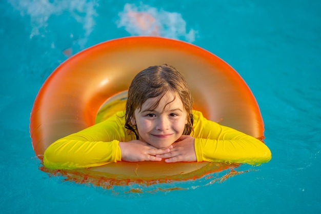 Kinderen spelen in het zwembad gelukkig jong kind genieten van zomervakantie buiten in het water in de swimmin