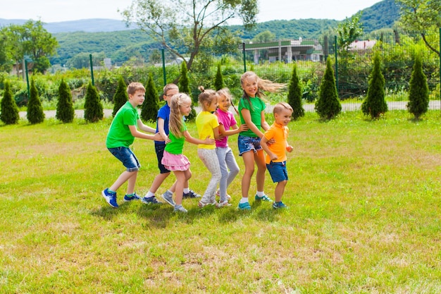 Kindergarten and school friends interact with each other. Preschoolers play with shoolchildren.