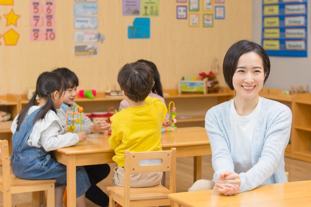 Kindergarten teacher playing with children