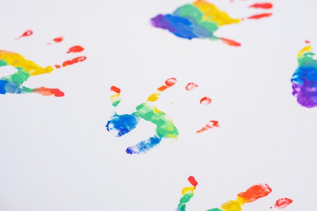 Kinderhandafdrukken in regenboogkleuren, op wit vel papier