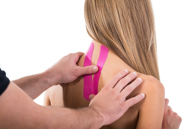 Kinesio tapes on the neck of a woman