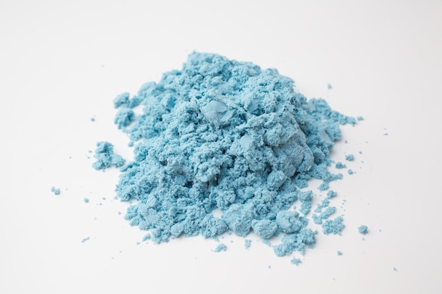 Kinetic blue sand on white background