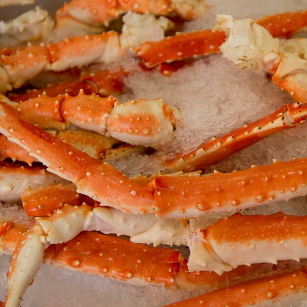 King crab legs on ice at a market stall, pike place market,\
seattle, washington state, usa