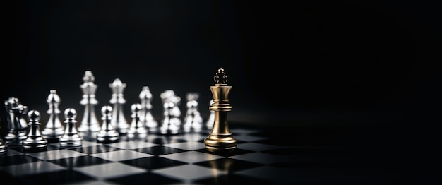 Фото Король золотых шахмат стоя противостоит серебряной шахматной команде