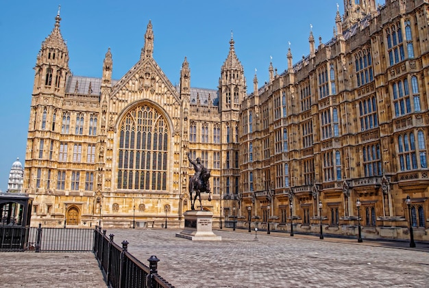 King monument in Old Palace Yard at the Palace of Westminster in London, the UK. The Westminster Palace is a meeting place for the two houses of the Parliament of the United Kingdom.