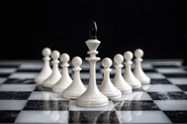 The king and pawns on a chess Board on a dark background.