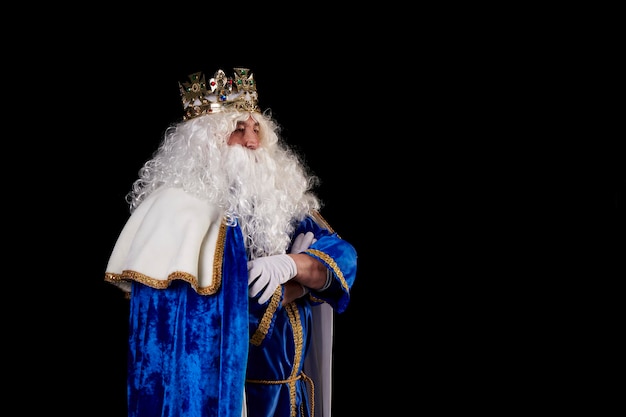 A king with white hair and beard on black background