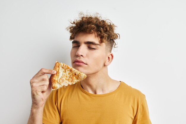 Kinky guy eating pizza posing closeup isolated background