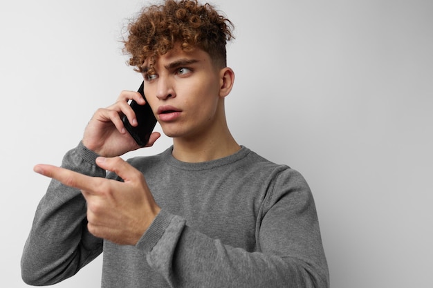 Kinky guy talking on the phone posing emotions isolated background
