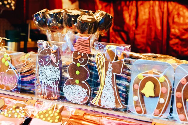 Kiosks with sweets and gingerbread souvenirs at the traditional European Christmas market in winter Riga in Latvia.