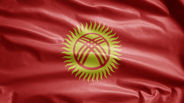 Photo kirghizia flag waving in the wind. close up of kyrgyzstan banner blowing, soft and smooth silk. cloth fabric texture ensign background. use it for national day and country occasions concept.