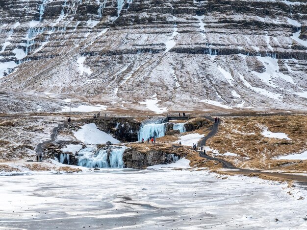 Kirkjufellfoss waterfall with its surrounding view water freeze the most popular landmark in Iceland