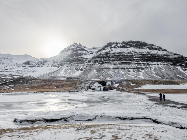 Kirkjufellfoss-waterval met zijn omringende uitzicht water bevriest de meest populaire bezienswaardigheid in IJsland