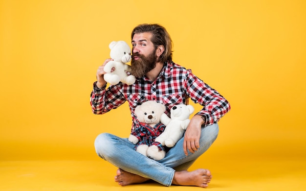 Kiss of love cheerful bearded man kissing teddy bear male feel playful with bear brutal mature hipster man play with toy happy birthday being in good mood happy valentines day