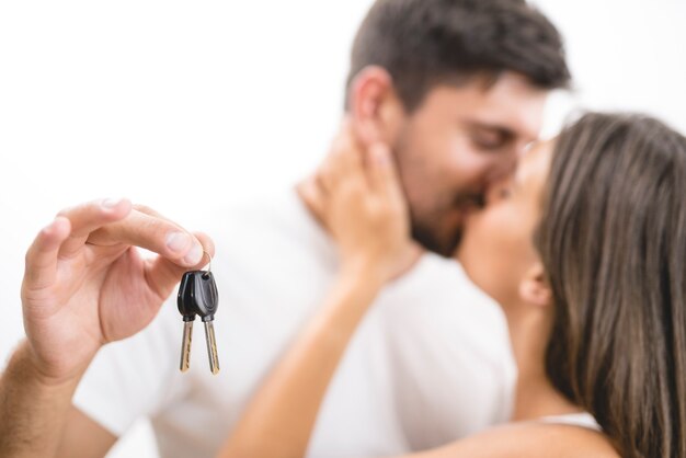 The kissing couple hold keys