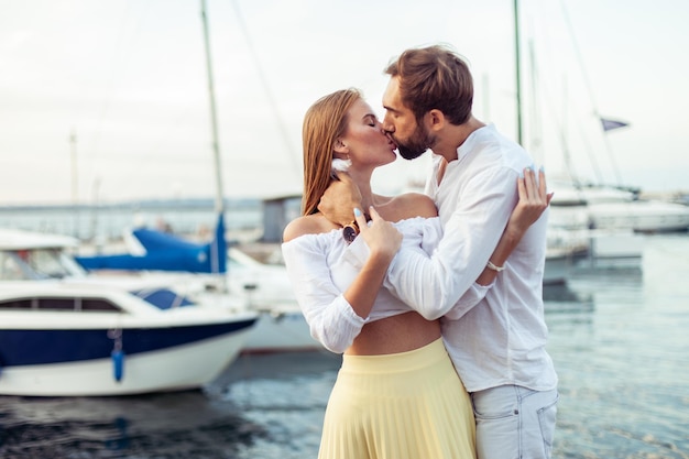 Kissing couple in love in the yacht club Romantic love concept