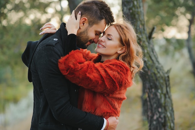 Kissing young couple in love in the autumn park