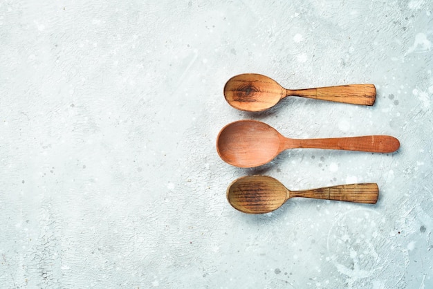 Kitchen background. Wooden spoons. Kitchen appliances. On a gray stone background. Top view.