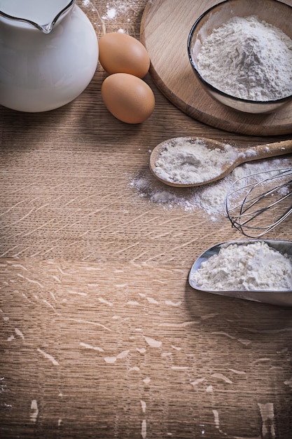 Kitchen composition eggs milk flour and tools.