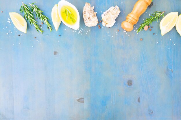 Photo kitchen cooking background with oil and spices on blue wooden table