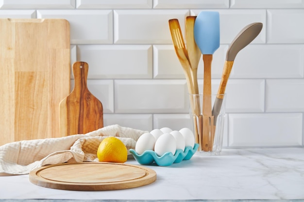 Kitchen countertop with cutting board wooden spatulas and napkin