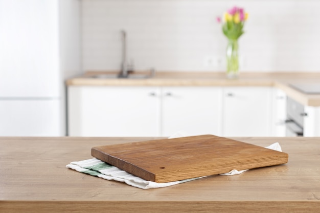 Kitchen cutting board on the kitchen table top on blur kitchen