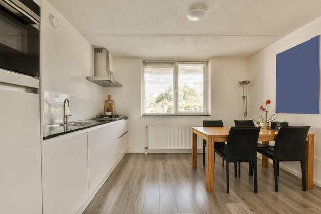 a kitchen and dining area with a table and chairs