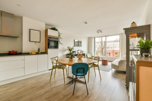 A kitchen and dining area with a table and chairs