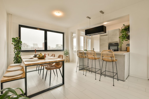 A kitchen and dining room with a table and chairs