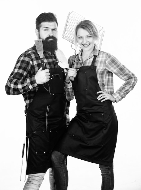 Kitchen equipment Family weekend Couple in love hold kitchen utensils Man bearded hipster and girl Preparation and culinary Tools for roasting meat Picnic barbecue food cooking recipe