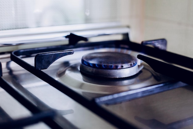 Kitchen gas hob stove cook with blue flames burning