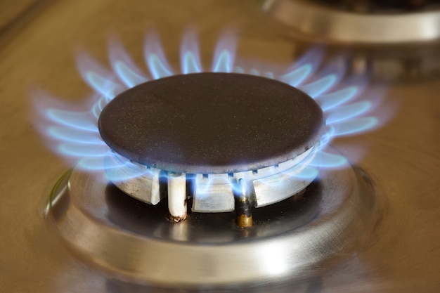 Kitchen gas stove with burning hot blue flame burner