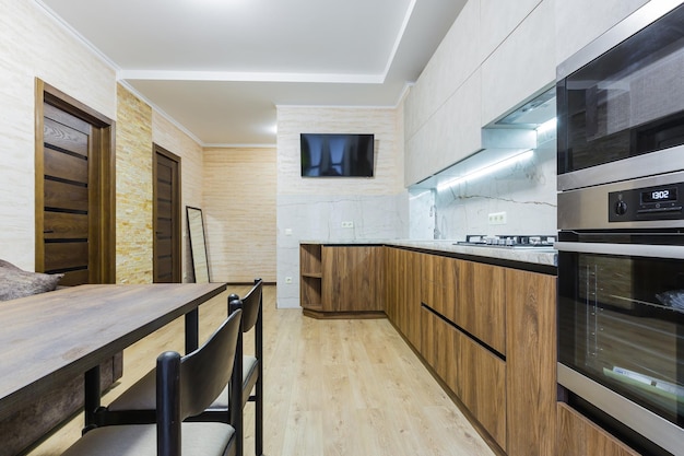 Kitchen interior with white furniture with wooden inserts