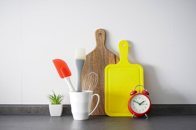 Kitchen items with a red alarm clock