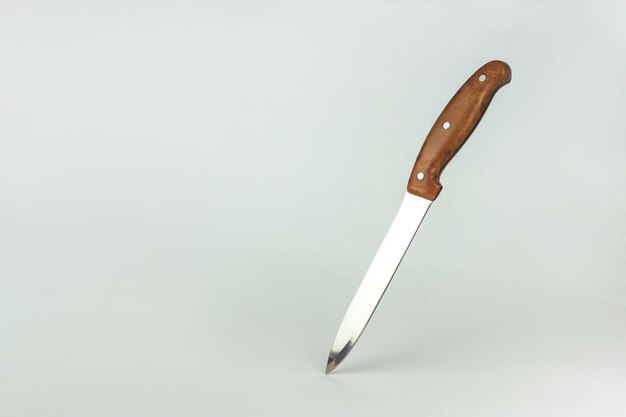 Kitchen knife balanced on its end Top view Free space for your text Chef restaurant or kitchen concept