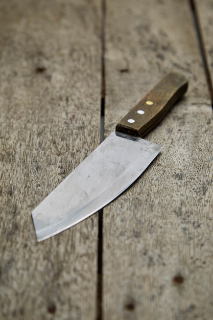 Kitchen knife on wooden background