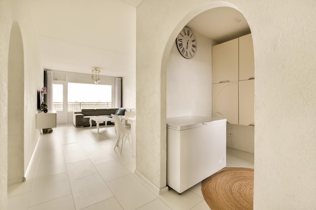 A kitchen and living room with white tile flooring