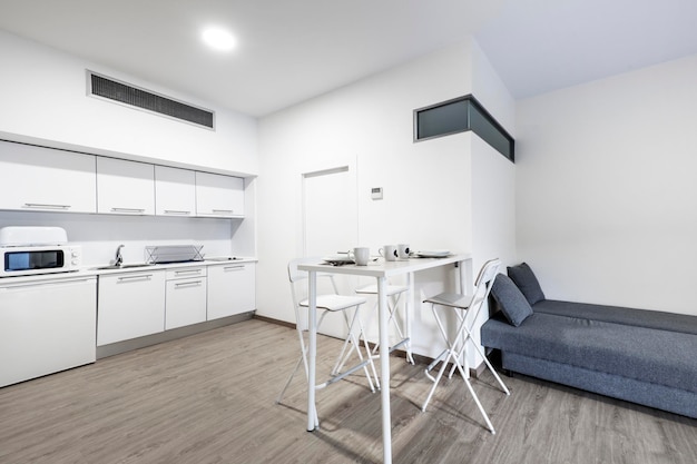 Kitchen and livingdining area in a vacation rental studio with breakfastonthetable service